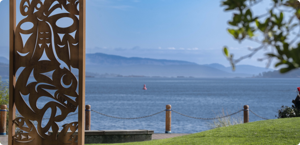 View of ocean looking past First Nations sculpture